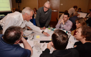 Steve Farlow (left) and Don McDermott lead a table discussion on drawing up a business model canvas.